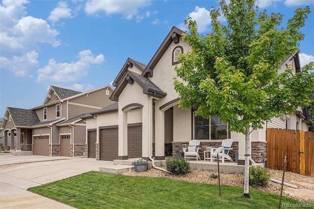 11511 E 118th Ave, Commerce City, CO 80640 - view of front of home with stone siding, stucco siding, a garage, and concrete driveway