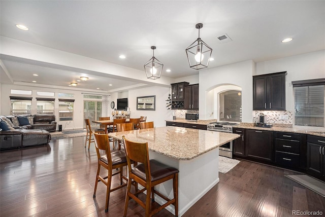11511 E 118th Ave, Commerce City, CO 80640 - kitchen featuring stainless steel appliances, open floor plan, decorative backsplash, and recessed lighting