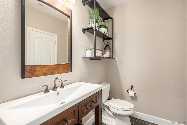 11511 E 118th Ave, Commerce City, CO 80640 - bathroom featuring toilet, vanity, tile patterned floors, and baseboards