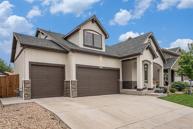11511 E 118th Ave, Commerce City, CO 80640 - view of front of house featuring stucco siding, stone siding, an attached garage, and driveway
