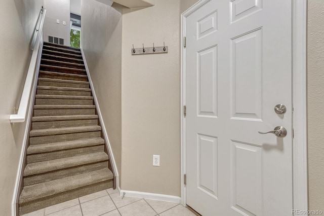 2943 W Riverwalk Cir Unit I, Littleton, CO 80123 - stairway featuring tile patterned flooring and baseboards