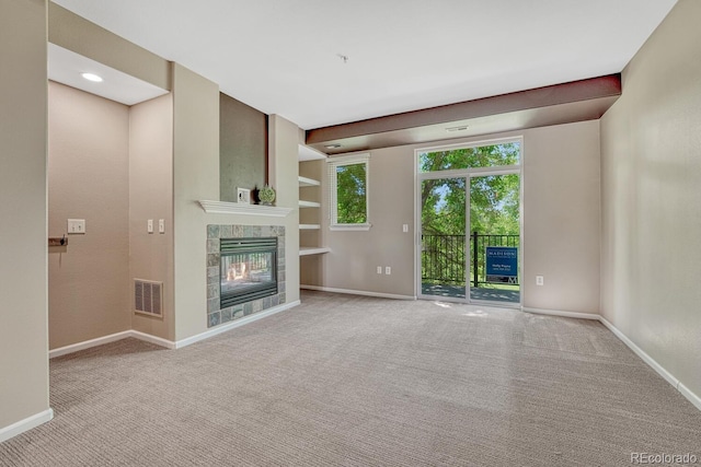 2943 W Riverwalk Cir Unit I, Littleton, CO 80123 - unfurnished living room featuring carpet flooring, a fireplace, and built in features