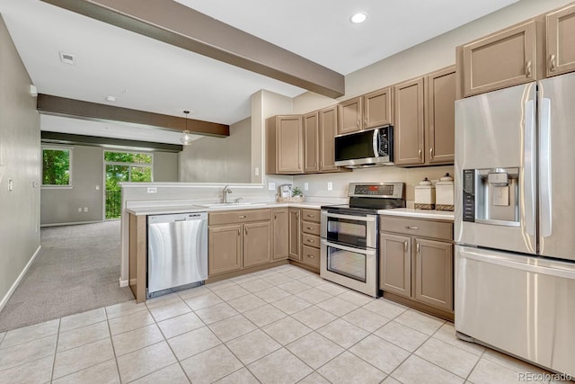 2943 W Riverwalk Cir Unit I, Littleton, CO 80123 - kitchen with stainless steel appliances, beam ceiling, light countertops, a peninsula, and light tile patterned flooring