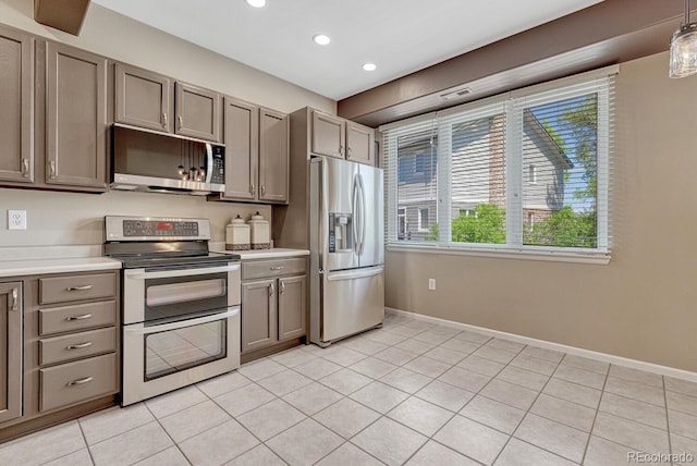 2943 W Riverwalk Cir Unit I, Littleton, CO 80123 - kitchen with stainless steel appliances, recessed lighting, light tile patterned flooring, light countertops, and gray cabinetry