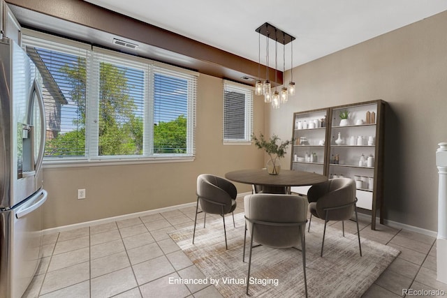 2943 W Riverwalk Cir Unit I, Littleton, CO 80123 - dining space featuring light tile patterned floors and a chandelier