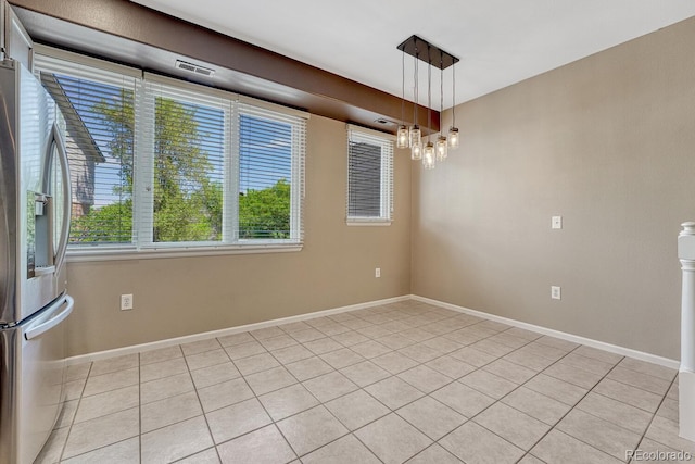 2943 W Riverwalk Cir Unit I, Littleton, CO 80123 - spare room featuring light tile patterned floors and a chandelier
