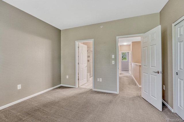 2943 W Riverwalk Cir Unit I, Littleton, CO 80123 - unfurnished bedroom with light carpet and ensuite bathroom