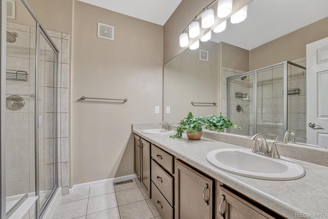 2943 W Riverwalk Cir Unit I, Littleton, CO 80123 - full bath with tile patterned flooring, double vanity, and a stall shower