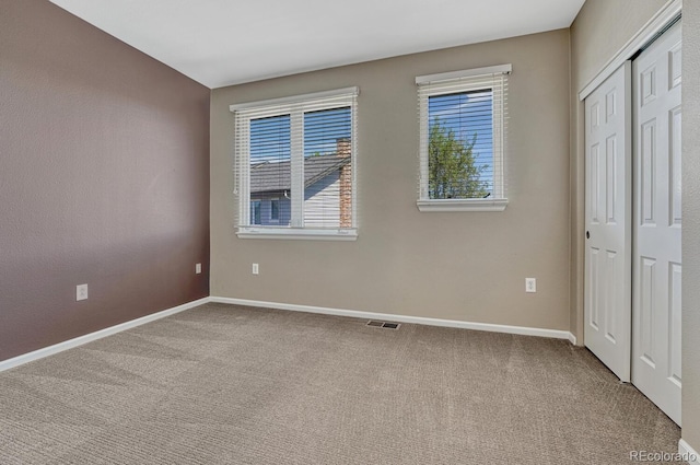 2943 W Riverwalk Cir Unit I, Littleton, CO 80123 - unfurnished bedroom with carpet flooring and a closet