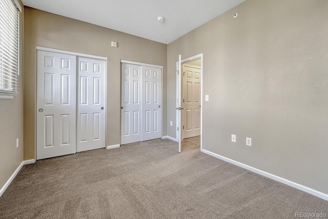 2943 W Riverwalk Cir Unit I, Littleton, CO 80123 - unfurnished bedroom with two closets and carpet floors