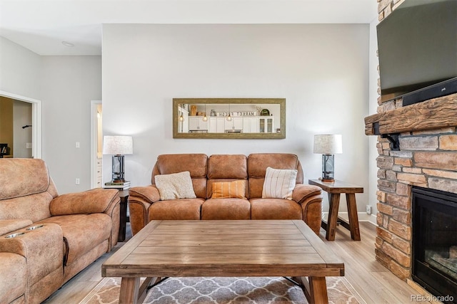 527 Antelope Dr E, Bennett, CO 80102 - living area featuring light wood-style flooring and a fireplace