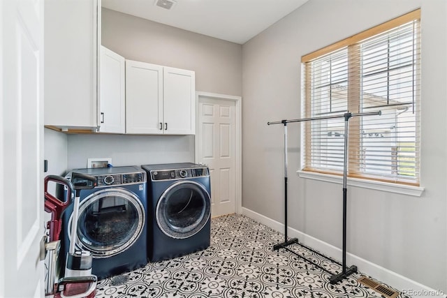 527 Antelope Dr E, Bennett, CO 80102 - laundry area with cabinet space, washing machine and dryer, healthy amount of natural light, and baseboards