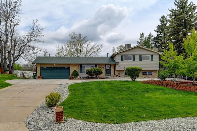 11310 W Center Ave, Lakewood, CO 80226 - split level home featuring a garage, concrete driveway, brick siding, and a front yard