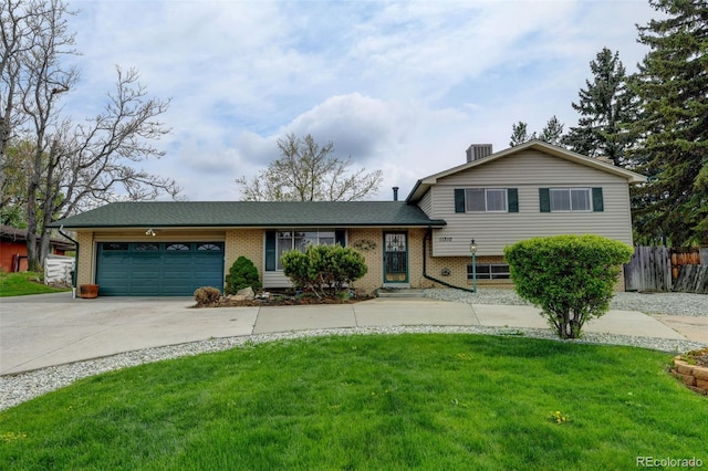 11310 W Center Ave, Lakewood, CO 80226 - tri-level home featuring brick siding, driveway, an attached garage, and central AC unit