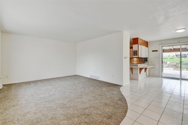 11310 W Center Ave, Lakewood, CO 80226 - unfurnished living room with light carpet and light tile patterned floors