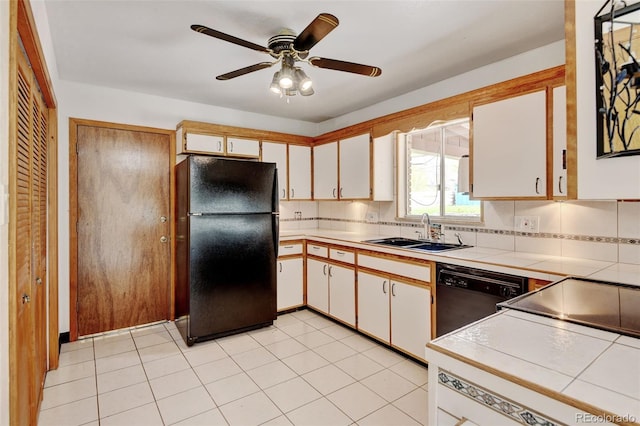 11310 W Center Ave, Lakewood, CO 80226 - kitchen with black appliances, a sink, tile counters, and tasteful backsplash