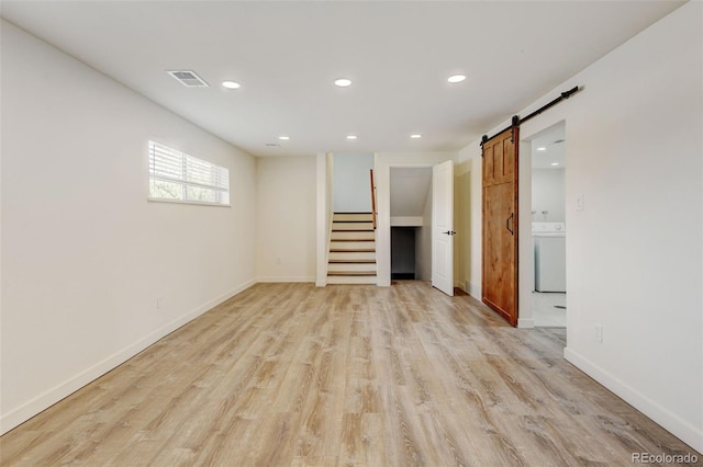 11310 W Center Ave, Lakewood, CO 80226 - unfurnished living room featuring washer / clothes dryer, recessed lighting, a barn door, light wood finished floors, and stairway