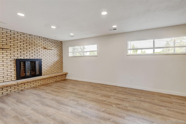 11310 W Center Ave, Lakewood, CO 80226 - unfurnished living room featuring baseboards, recessed lighting, wood finished floors, and a brick fireplace