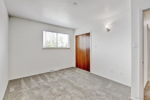11310 W Center Ave, Lakewood, CO 80226 - unfurnished bedroom featuring carpet flooring, a closet, and baseboards