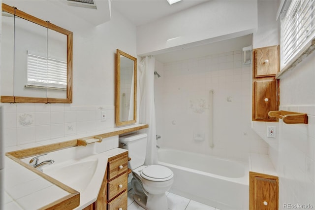 11310 W Center Ave, Lakewood, CO 80226 - full bath with toilet, vanity, shower / bath combo, tile patterned floors, and tile walls