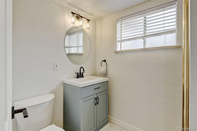 11310 W Center Ave, Lakewood, CO 80226 - half bathroom featuring healthy amount of natural light, vanity, toilet, and tile patterned flooring