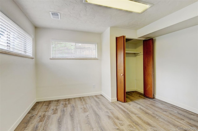 11310 W Center Ave, Lakewood, CO 80226 - unfurnished bedroom featuring wood finished floors, a closet, and baseboards