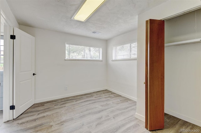 11310 W Center Ave, Lakewood, CO 80226 - unfurnished bedroom featuring wood finished floors, baseboards, and a closet