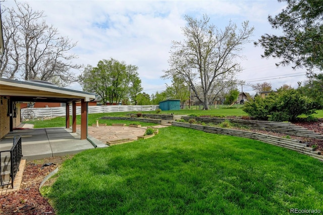 11310 W Center Ave, Lakewood, CO 80226 - view of yard with a patio area, a storage unit, and an outdoor structure