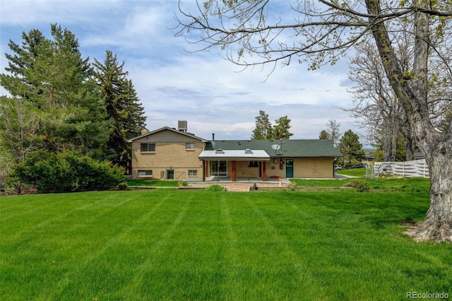 11310 W Center Ave, Lakewood, CO 80226 - back of house with a patio and a lawn
