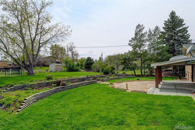 11310 W Center Ave, Lakewood, CO 80226 - view of yard featuring a patio area and a vegetable garden