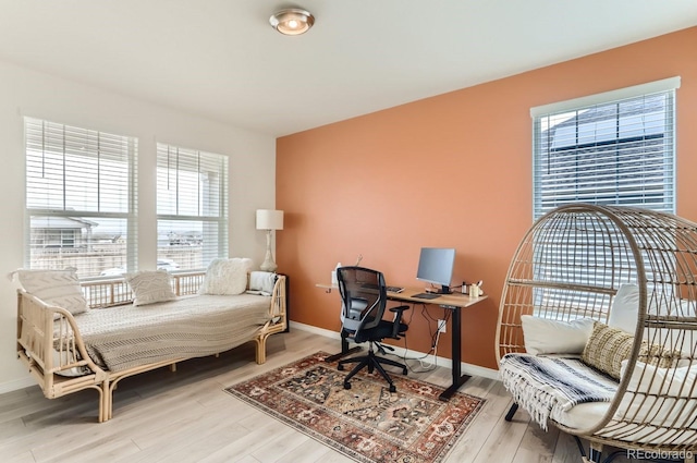 office space featuring baseboards and wood finished floors