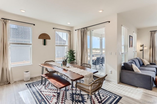 dining room with light wood-type flooring, recessed lighting, and baseboards