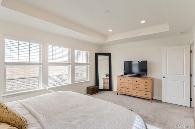 bedroom featuring light carpet, baseboards, recessed lighting, and a raised ceiling