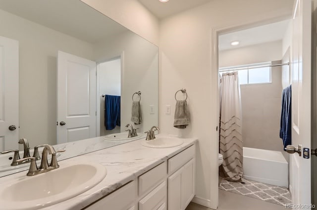 full bath featuring shower / bath combo with shower curtain, double vanity, and a sink