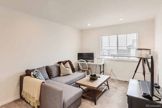 living room featuring baseboards, recessed lighting, and light colored carpet