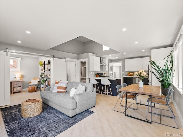 2517 W 44th Ave, Denver, CO 80211 - living area featuring a barn door, light wood-type flooring, recessed lighting, and baseboards