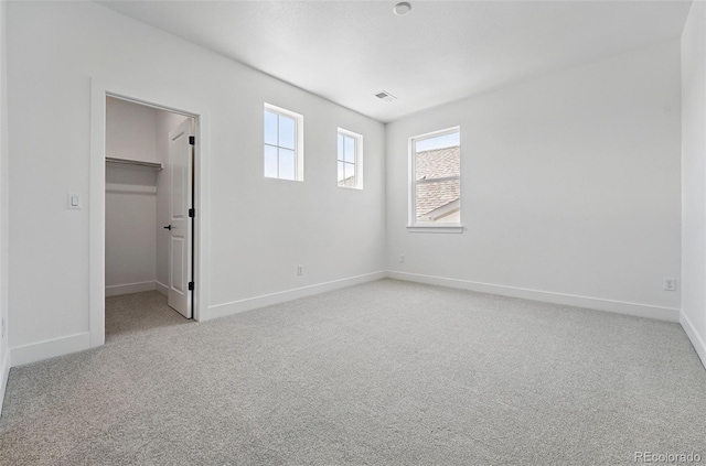 16565 Black Rose Cir, Parker, CO 80134 - unfurnished bedroom featuring light colored carpet, a spacious closet, baseboards, and a closet