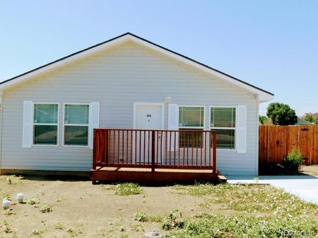 rear view of house featuring a wooden deck