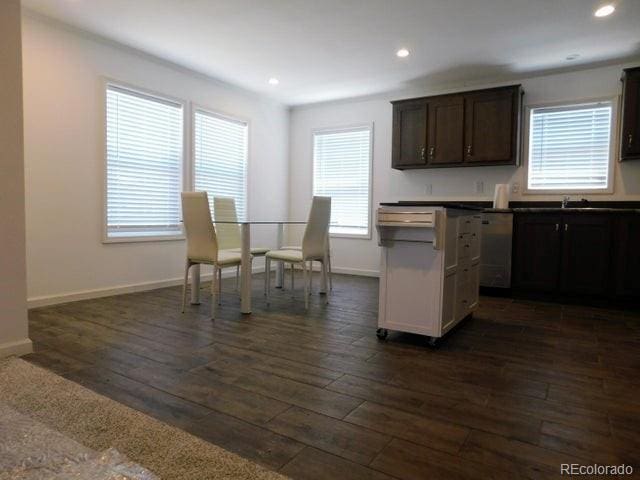 kitchen with dark brown cabinets, dishwasher, and dark wood-type flooring