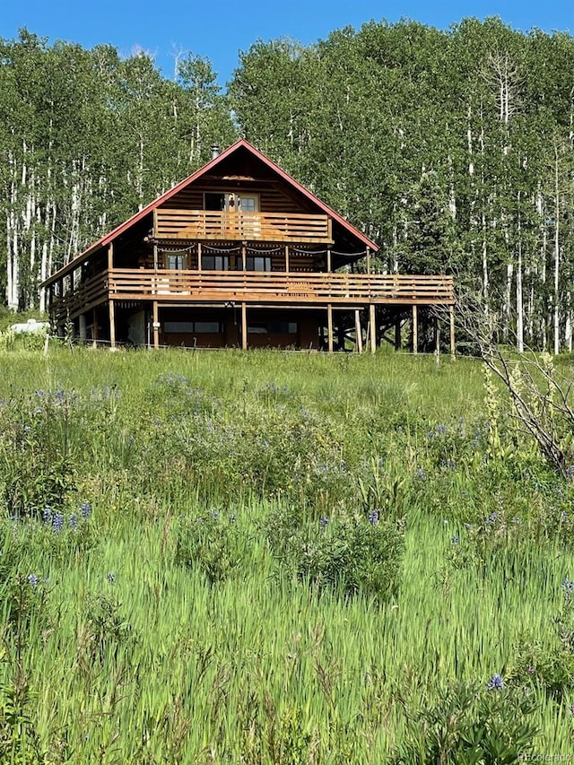 back of house with a wooden deck