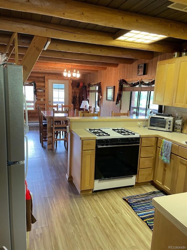 kitchen with beamed ceiling, light wood-type flooring, and white appliances