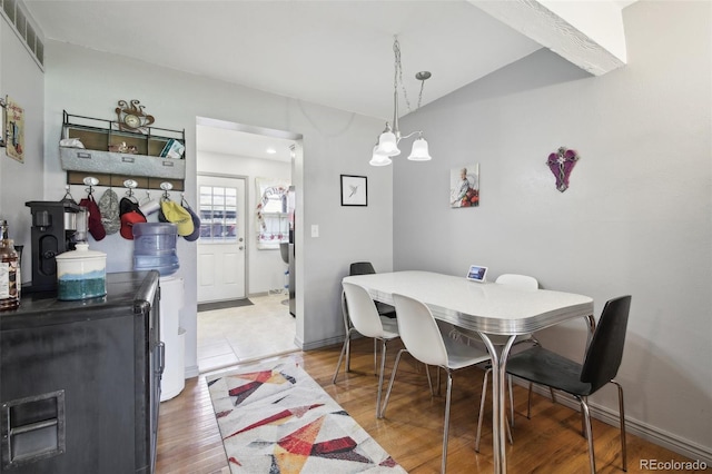 dining room with a notable chandelier and hardwood / wood-style floors