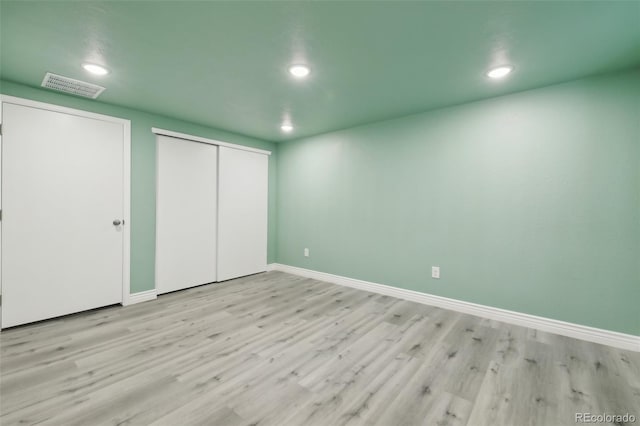 unfurnished bedroom with wood-type flooring and a closet