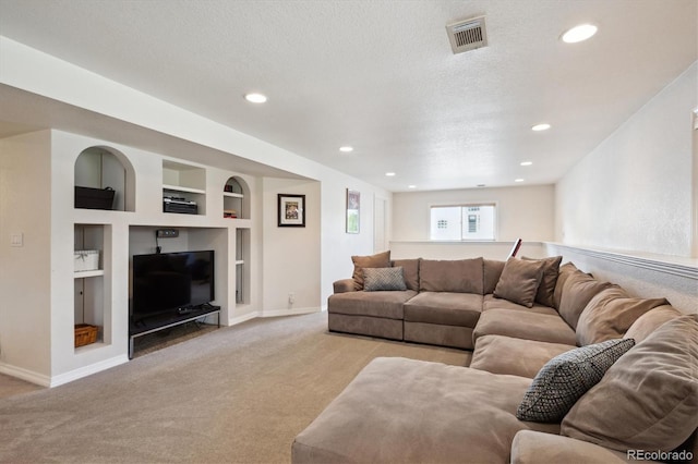 carpeted living area with visible vents, baseboards, built in features, and recessed lighting