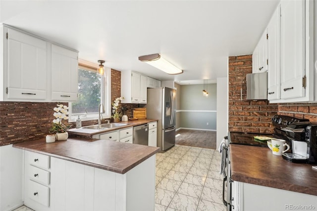 8732 W Arbor Ave, Littleton, CO 80123 - kitchen featuring stainless steel appliances, dark countertops, light marble finish flooring, a peninsula, and tasteful backsplash