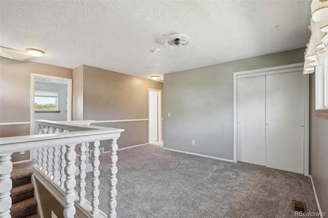 8732 W Arbor Ave, Littleton, CO 80123 - corridor featuring carpet and a textured ceiling