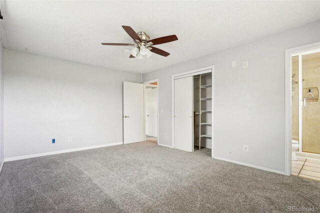 8732 W Arbor Ave, Littleton, CO 80123 - unfurnished bedroom featuring a textured ceiling, carpet flooring, a closet, ensuite bathroom, and a ceiling fan