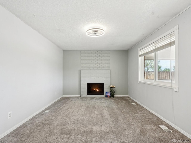 8732 W Arbor Ave, Littleton, CO 80123 - unfurnished living room with a textured ceiling, carpet, and a brick fireplace