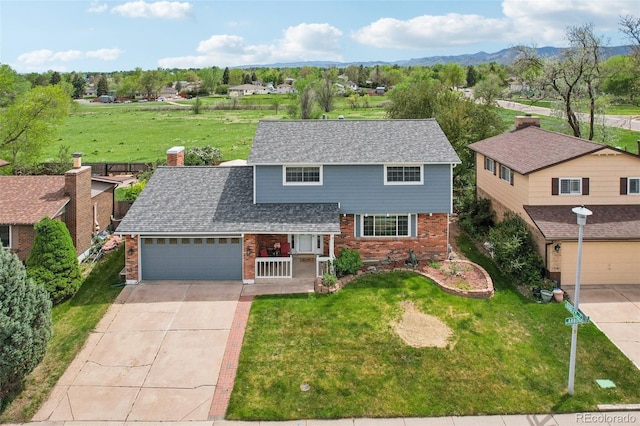 8732 W Arbor Ave, Littleton, CO 80123 - traditional-style home with brick siding, concrete driveway, covered porch, and a front yard
