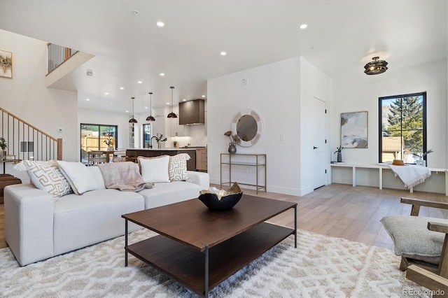 living room with plenty of natural light and light hardwood / wood-style flooring